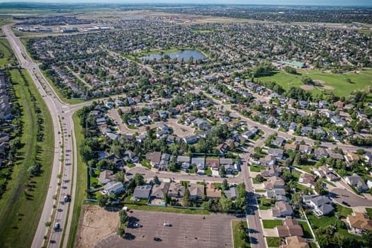 Elevated panorama of Willowgrove, showcasing the neighborhood's modern aesthetics intertwined with pockets of lush green, epitomizing Saskatoon's suburban beauty