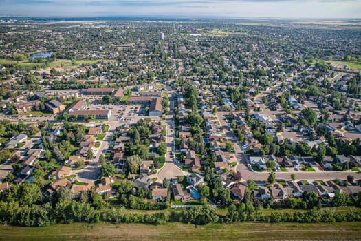 Soaring over Lakeview in Saskatoon, this bird's-eye capture magnifies the neighborhood's tranquil waters, verdant parks, and the serene rhythm of Saskatchewan living