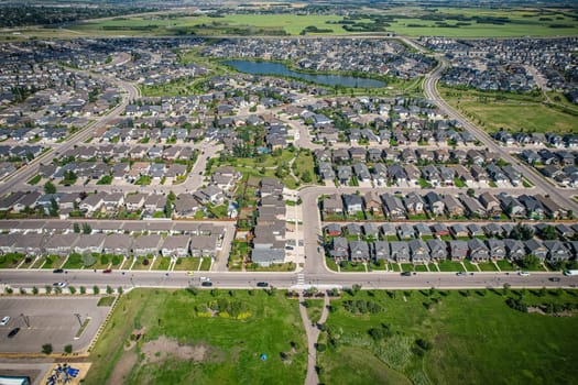 Captivating aerial shot of Stonebridge in Saskatoon, highlighting the harmonious blend of modern architecture and Saskatchewan's verdant surroundings.