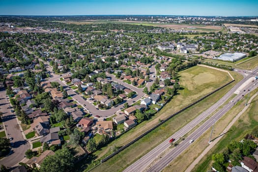 Aerial journey over Silverspring in Saskatoon, revealing a harmonious blend of suburban life, green expanses, and the distinct charm of Saskatchewan's landscapes.