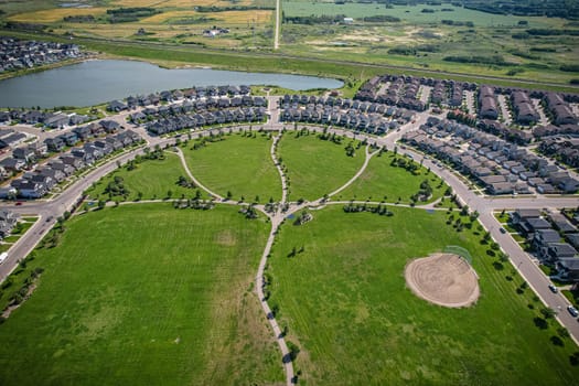 Captivating aerial shot of Stonebridge in Saskatoon, highlighting the harmonious blend of modern architecture and Saskatchewan's verdant surroundings.