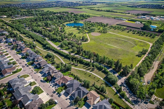 Aerial journey over Silverspring in Saskatoon, revealing a harmonious blend of suburban life, green expanses, and the distinct charm of Saskatchewan's landscapes.