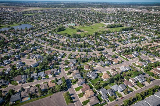 Elevated panorama of Willowgrove, showcasing the neighborhood's modern aesthetics intertwined with pockets of lush green, epitomizing Saskatoon's suburban beauty
