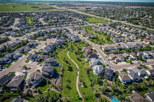 Elevated panorama of Willowgrove, showcasing the neighborhood's modern aesthetics intertwined with pockets of lush green, epitomizing Saskatoon's suburban beauty