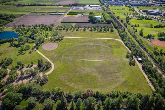 Aerial journey over Silverspring in Saskatoon, revealing a harmonious blend of suburban life, green expanses, and the distinct charm of Saskatchewan's landscapes.