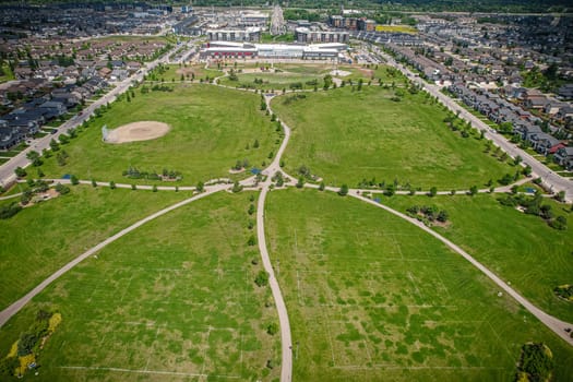 Captivating aerial shot of Stonebridge in Saskatoon, highlighting the harmonious blend of modern architecture and Saskatchewan's verdant surroundings.