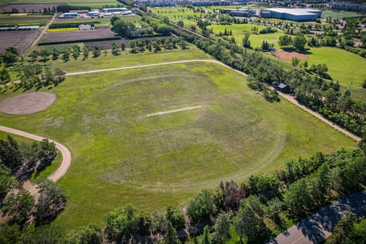 Aerial journey over Silverspring in Saskatoon, revealing a harmonious blend of suburban life, green expanses, and the distinct charm of Saskatchewan's landscapes.