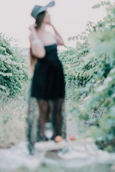 Woman at autumn winery. Portrait of happy woman holding glass of wine and enjoying in vineyard. Elegant young lady in hat toasting with wineglass smiling cheerfully enjoying her stay at vineyard