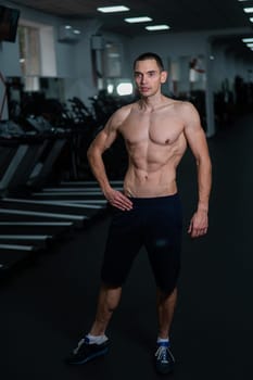 Shirtless man with sculpted body in the gym