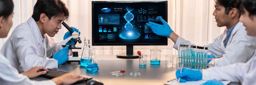 Dedicated scientist group working on advance biotechnology computer software to study or analyze DNA data after making scientific breakthrough from chemical experiment on medical laboratory. Neoteric