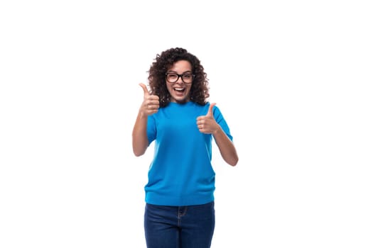 young cheerful curly woman with black hair dressed in a blue corporate t-shirt with print mockup.