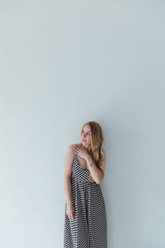 Portrait of beautiful blonde woman in light summer dress