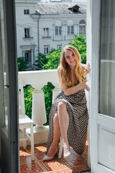 Portrait of beautiful blonde woman in light summer dress