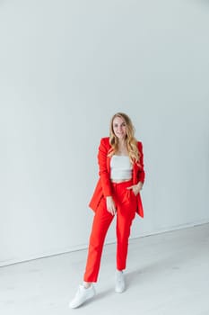 Beautiful blonde woman in red business suit