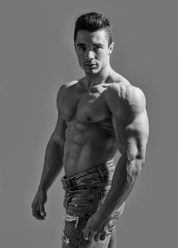 Muscles in Motion: Captivating Image of an Attractive, Shirtless Male Bodybuilder. A shirtless man posing for a picture