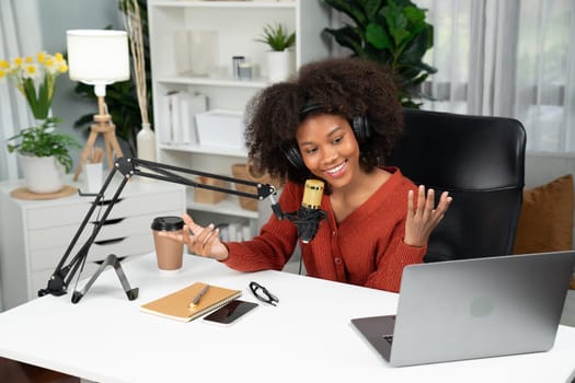 Host channel of beautiful African woman talking in online broadcast teaching marketing influencer, with listeners in broadcast or online. Concept of anywhere at work place. Tastemaker.