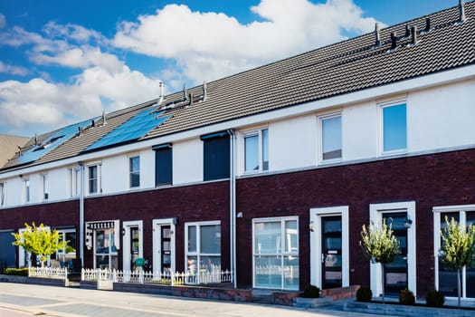 Dutch Suburban area with modern family houses, newly built modern family homes in the Netherlands, dutch family houses in the Netherlands, Row of modern houses in a contemporary neighborhood