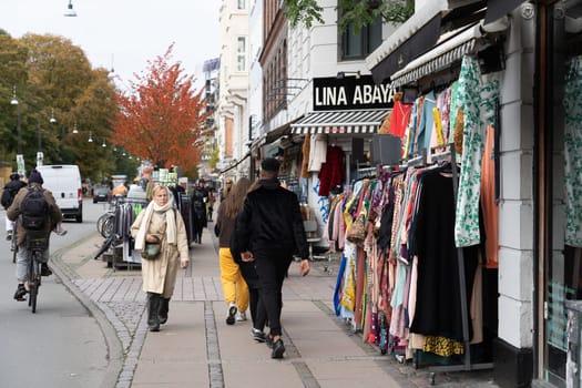 Copenhagen, Denmark - October 18, 2022: People and shops on Norrebrogade in Norrebro district