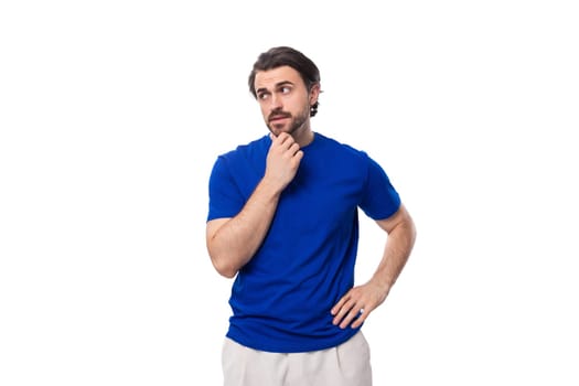 young smart handsome european man with black hair and beard dressed casually against the background with copy space.