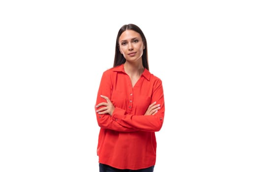 pretty young business woman with black hair dressed in a red shirt on a white background with copy space.