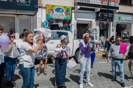 anti macho and racist demonstration in front of the ecuadorian government ministry. afro woman and indigenous woman with megaphone outraged. women's day. women empowerment. High quality photo