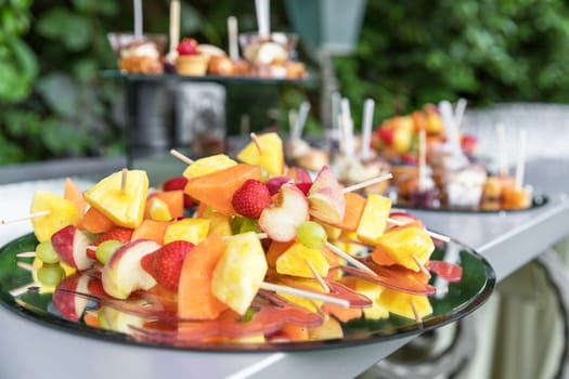 Mixed exotic fruits on skewers, party healthy snack. Party. Events.