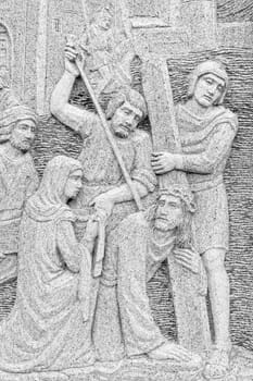 Bas-relief of Jesus restrained, captured and guided by the guard.