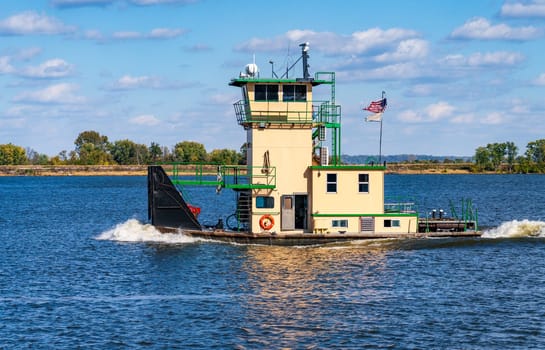 Tugboat or pusher boat leaves Lock and Dam no. 12 on Upper Mississippi near Hannibal in Missouri