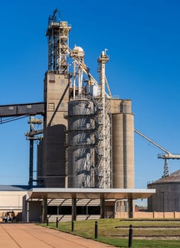 Side view of large grain processing and storage bins or silos in East St Louis in Illinois