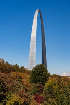 View across green planting of Gateway arch park to the Gateway Arch in downtown St Louis Missouri