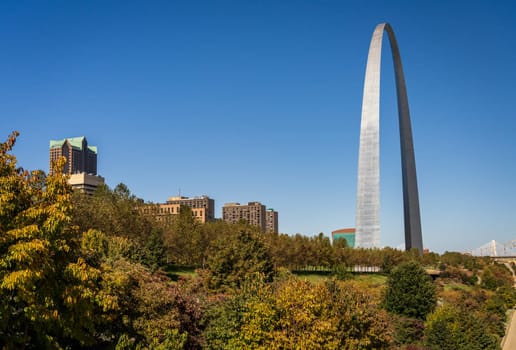 View across green planting of Gateway arch park to the Gateway Arch in downtown St Louis Missouri