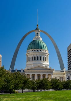 Dome of the old Courthouse in St Louis Missouri against the blue sky and the famous Gateway Arch framing the building