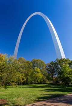 View across green lawn of National Park to Gateway Arch from Basilica of Saint Louis in St Louis Missouri