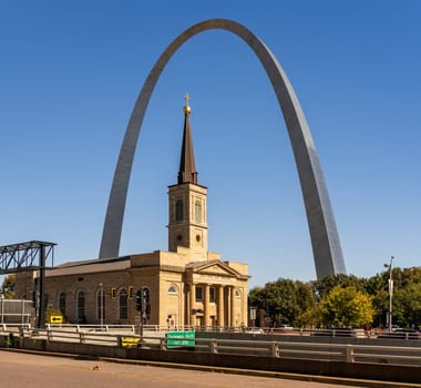 Exterior of the Basilica of Saint Louis, King of France framed by the Gateway Arch in St Louis Missouri