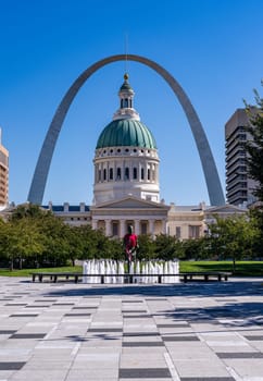 Old Courthouse in St Louis Missouri and the Gateway Arch with statue dressed in local red football shirt