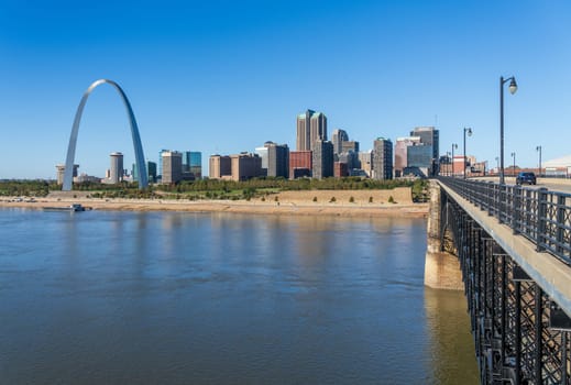 St Louis, MO - October 21, 2023: Low water levels in Mississippi river give unusual view of the Gateway arch by the riverbank seen from Eads Bridge