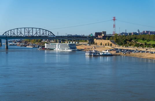St Louis, MO - 21 October 2023: Viking Mississippi river cruise boat docked on riverbank levee with low water levels in river seen from Eads Bridge