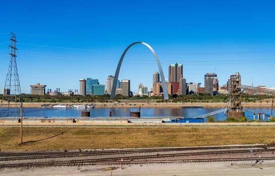 East St Louis, IL - October 21, 2023: Low water levels in Mississippi river give unusual view of the Gateway arch by the riverbank in Illinois