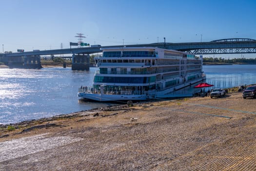 St Louis, MO - 21 October 2023: Viking Mississippi river cruise boat docked on riverbank levee with low water levels in river