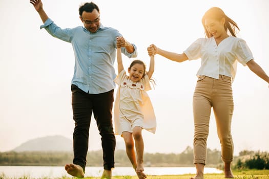 Happy family taking a walk in a beautiful park on a sunny spring day, feeling the joy and the togetherness of being outside and enjoying the season, Happy family day