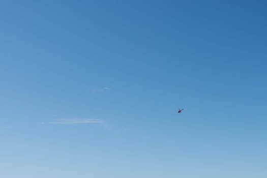 beautiful blue sky background with a small helicopter personal there is a place for an inscription. High quality photo