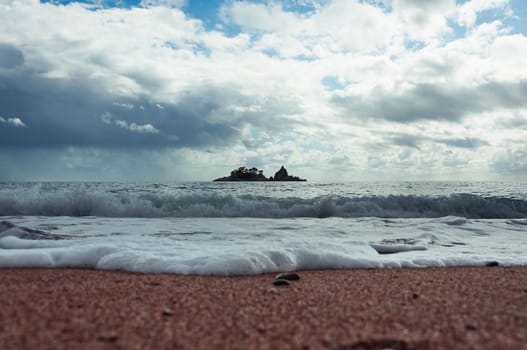 landscape photo of an evening beach overlooking the sea, an island can be seen in the distance, a photo of a sunset on the sea. High quality photo