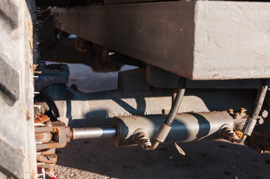 Detail of the interior of an old tractor in an industrial environment.close-up on metal parts in a loader. High quality photo