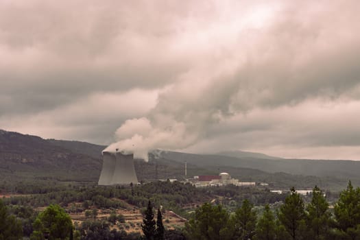 The spanish typical village of Cofrentes, with its castle in the foreground and its nuclear plant in the background. High quality photo