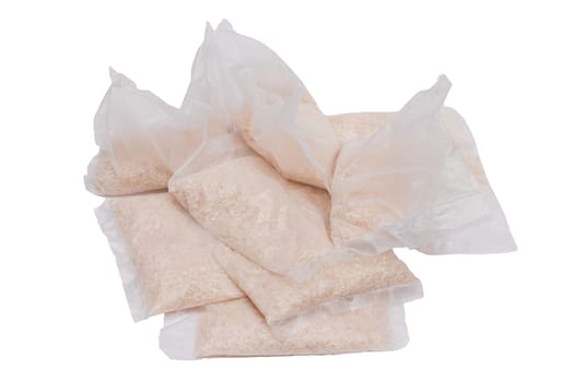 A Plastic Bags of White Long Grain Rice - Isolated on White Background. Small Transparent Packages with Dry Rice - Isolation