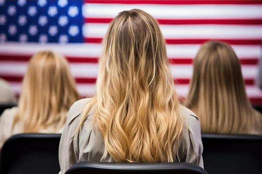 Blonde girl against the background of a blurred US flag.