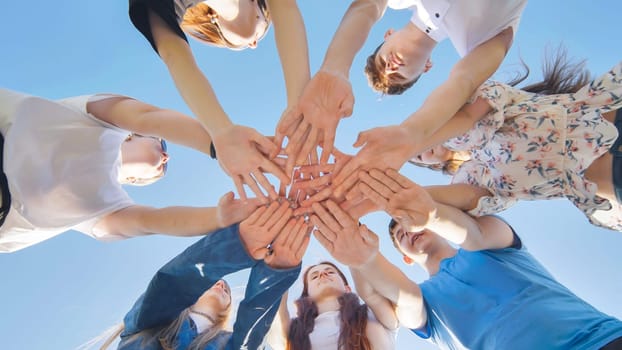 Friends putting their hands together in a sign of unity and teamwork. Just the hands