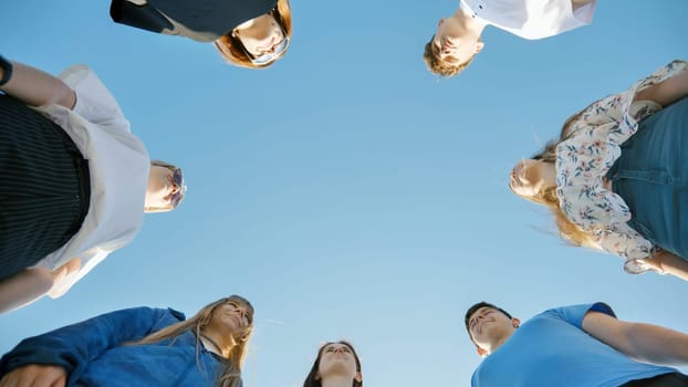 Young boys standing in a circle. View from below