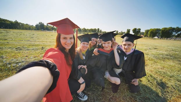 College alumni take selfies in the meadow