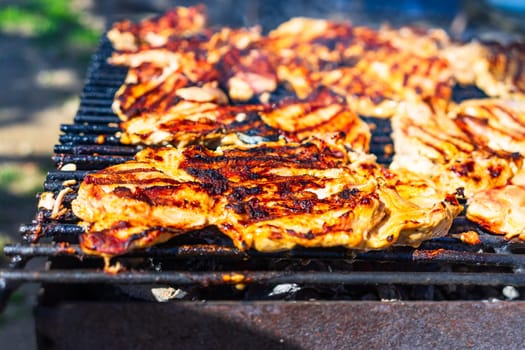 Chicken and pork steak grilled on a charcoal barbeque. Top view of camping tasty barbecue, food concept, food on grill and detail of food on the grill